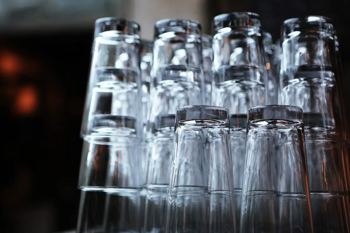 Clean glasses stacked behind a bar