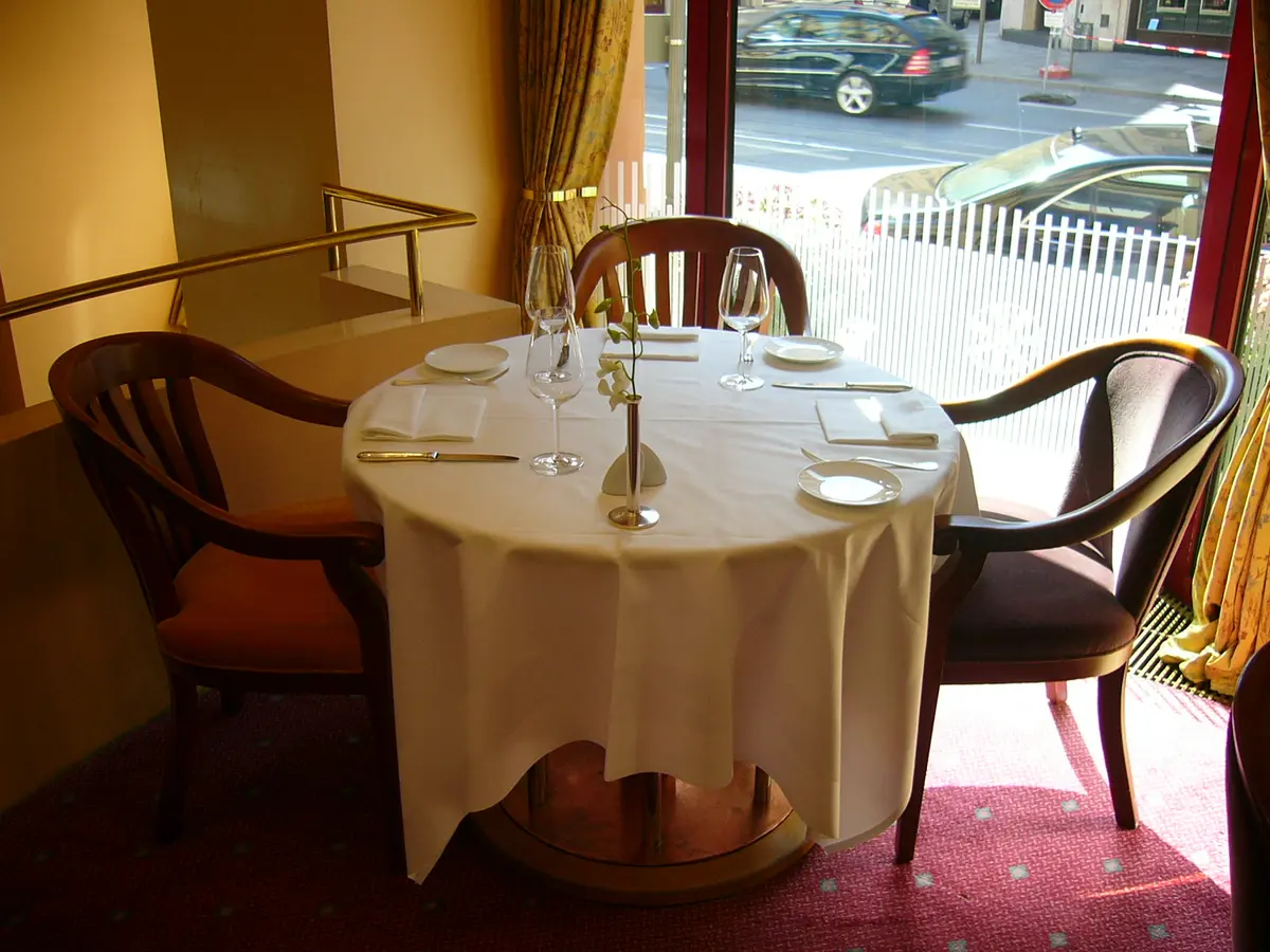 A white tablecloth table laid for two
