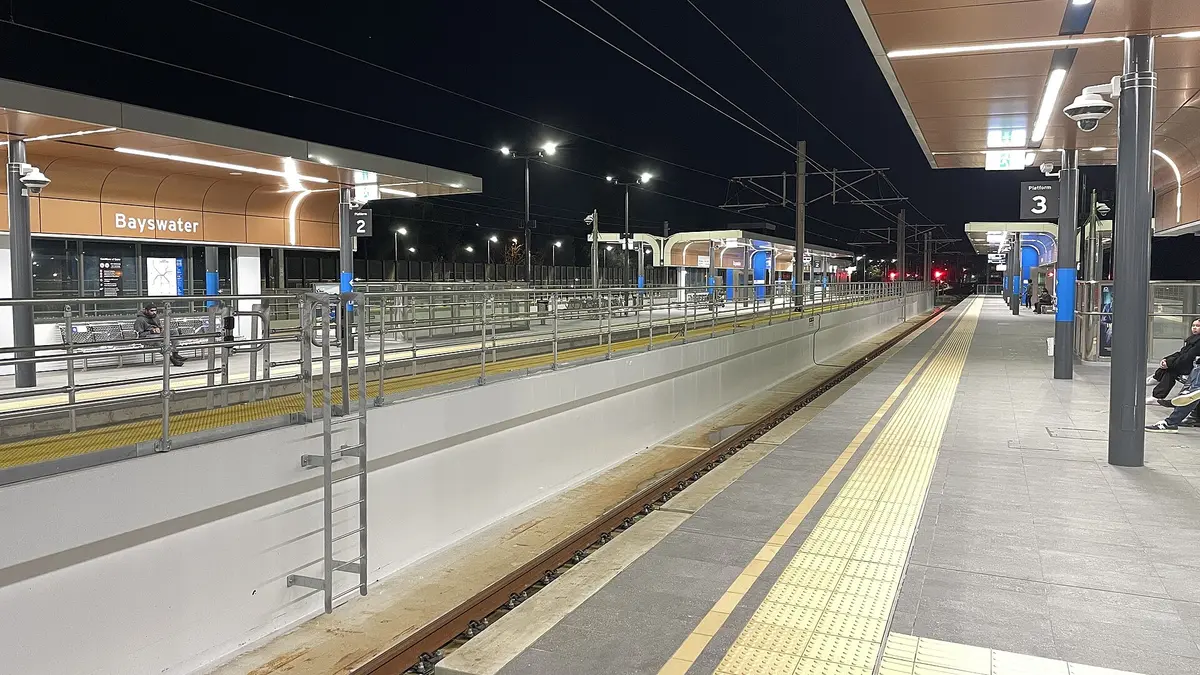 An empty railway platform lit at night
