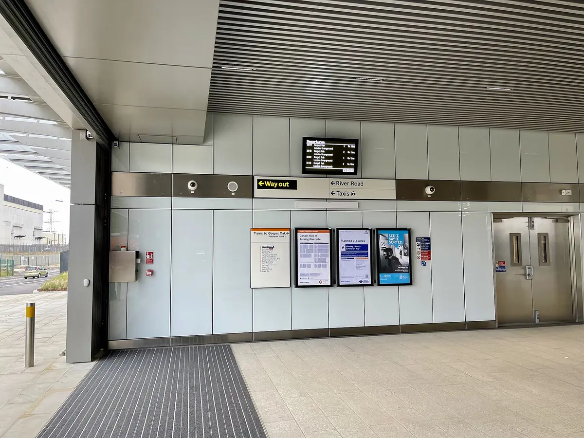 A quiet station entrance with a departure board